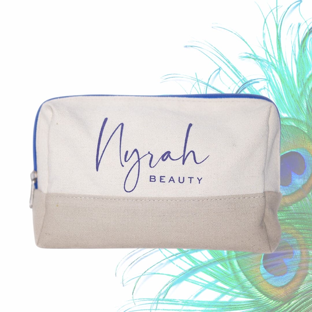 NYRAH BEAUTY Recycled Cotton Cosmetics Travel-Wash Bag front view with peacock feathers in background