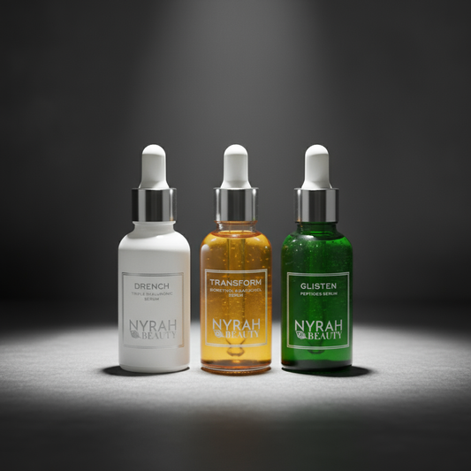Three Nyrah Beauty skincare serum bottles on a dark background