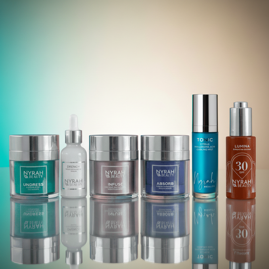 Collection of Nyrah Beauty skincare products on a reflective surface with a gradient background